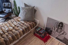 Unassuming bed and Eames Lounger in the bedroom