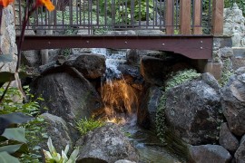 Wooden bridge over the waterfalls with beautiful lighting