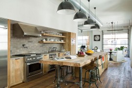 Wooden island and lighting give this kitchen the industrial touch [Design: SUBU Design Architecture]