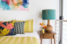 Bedding and pillow covers complement the wall art in the bedroom [Design: Nest Designs]