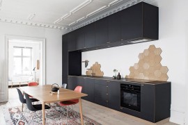 Black standalone unit in the kitchen steals the show [Design: Nicolaj Bo]