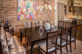 Brick wall offers a lovely backdrop for the colorful wall art piece
