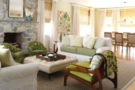 Chic beach style living room with a tufted ottoman as coffee table [Design: Tara Seawright]