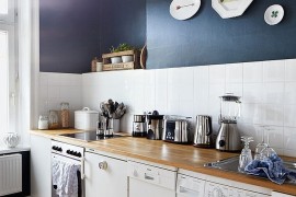 Cool bluish-gray on wall transforms this tiny kitchen [From: Brita Sönnichsen Photogrphy]