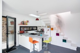 Corner kitchen under the stairs with a skylight [Photography: Martin Argyroglo]