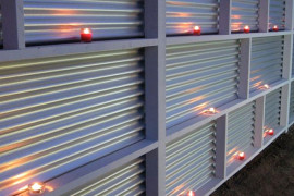 Corrugated metal fence with candles