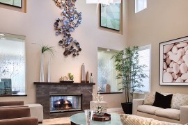 Giant metallic wall art installation in the high ceiling living room [Design: International Custom Designs]