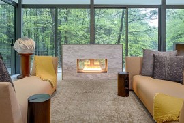 Glass walls bring the forest canopy indoors