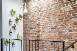 Gorgeous wall planters next to the staircase with skylight above