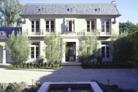 Large stucco home with a shingled roof