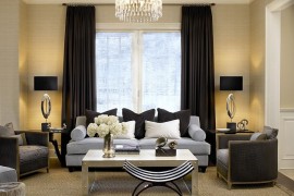 Light color scheme of the living room complements the dark drapes perfectly