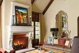Mediterranean style family room with a comfy ottoman at its heart [Design: Astleford Interiors]