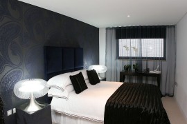 Refined contemporary bedroom with dark sheer curtains
