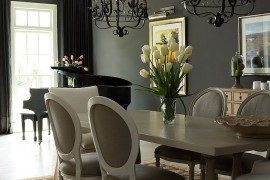 Sophisticated traditional dining room with black curtains in the backdrop