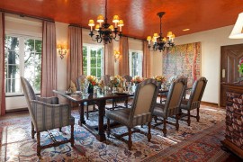 Textured orange ceiling becomes the focal point of this dining room