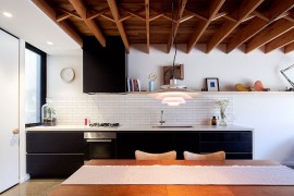 Tiled kitchen backsplash in white along with black shelves