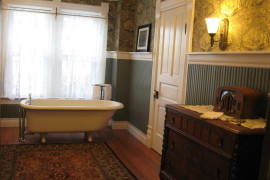 Elegant Victorian beadboard bathroom with warm lighting