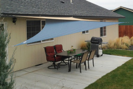 Shade sail above outdoor dining room