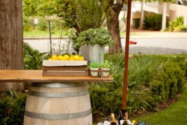 Relaxing outdoor lounge with wine barrels and umbrella