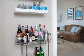 A vintage bar cart and a few floating shelves is all you need for a tiny home bar