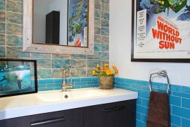 Bathroom walls come to life with a poster of documentary made by legendary oceanographer Jacques Cousteau!