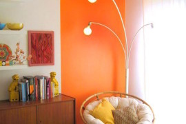 Bright orange reading nook that goes right up to the ceiling