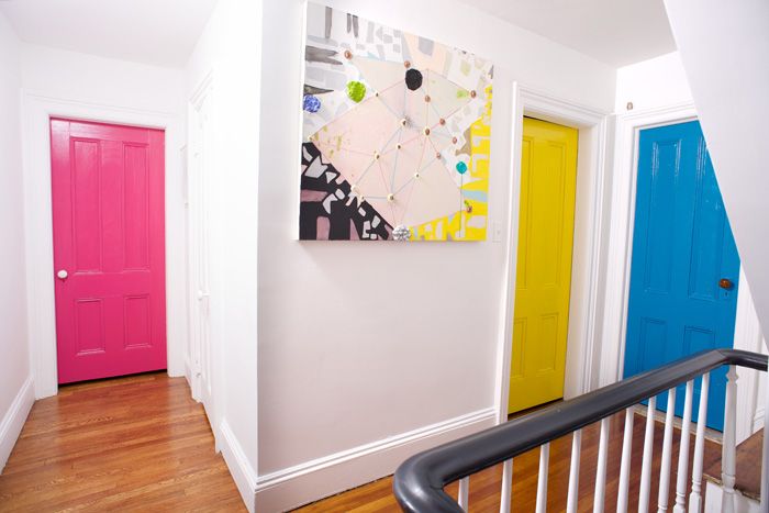 Brightly painted doors stand out against white walls