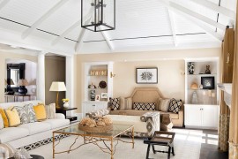Cheerful and relaxing beach style living room with a gold coffee table [Design: Weaver Design Group]