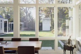 Chic modern outdoor dining area on a screened-in porch