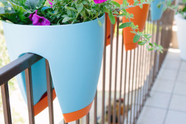 Colorful planters that sit on your balcony railing