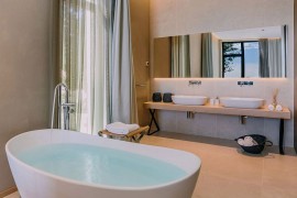 Contemporary bathroom with a standalone bathtub and a sleek vanity with twin sinks