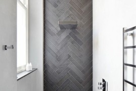 Contemporary shower featuring herringbone tile