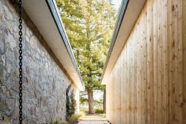 Contrasting sections of the home in stone and cedar