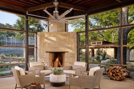 Cozy sunroom with a limestone fireplace