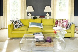 Cozy yellow couch and acrylic coffee table enliven the living space