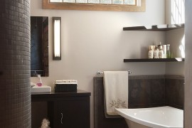 Floating shelves in the corner above the bathtub