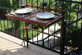 Foldable table attached to balcony