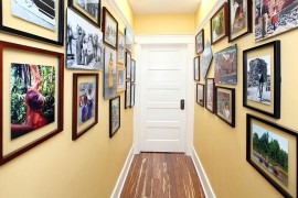 Gallery walls create a beautiful  entry with initing warmth and color
