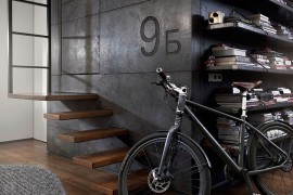 Giant dark cube in the living room made from custom dark concrete panels