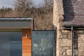 Glass and timber modern structure meets lovely cottage in stone