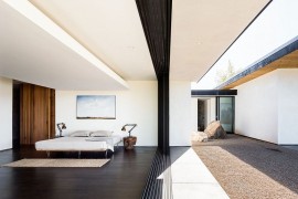 Glass doors bring the outdoors into the bedroom with ease