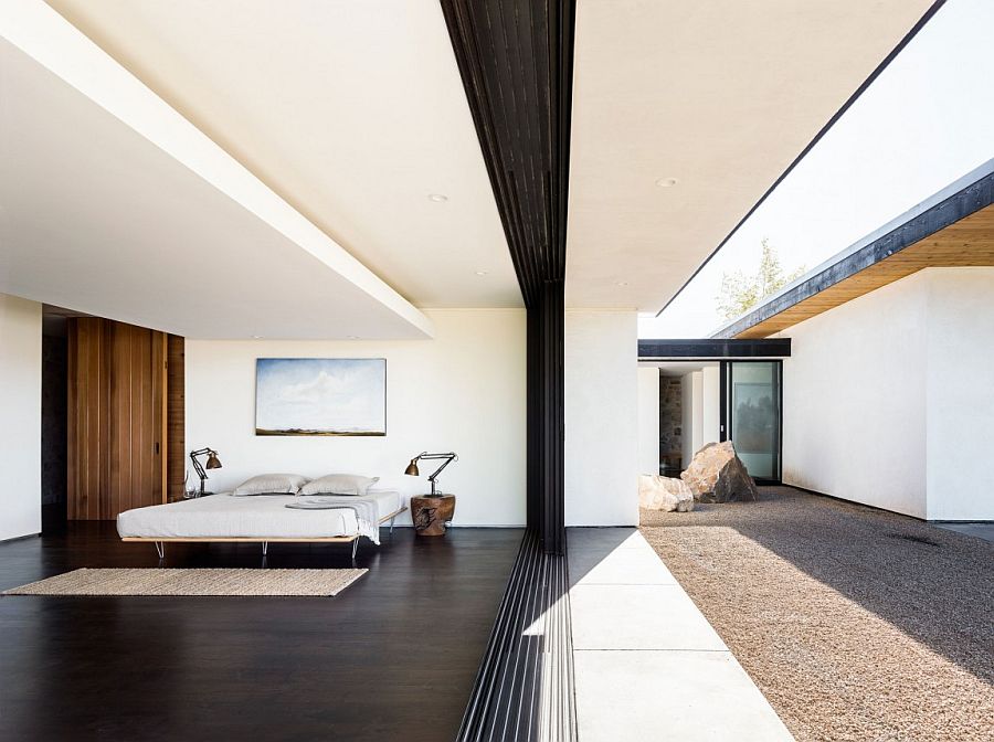 Glass doors bring the outdoors into the bedroom with ease