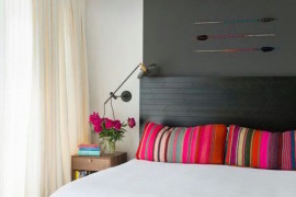 Gray wall color blocking paired with bright pink accessory accents
