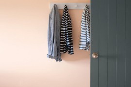 Hanging wall hooks in a peach entryway