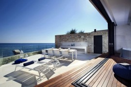 Heritage stone walls of old city meet modern glass surfaces at House Sperone