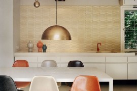 Ingenious pendant lighting and lovely tiled backdrop bring back the essence of the 60s