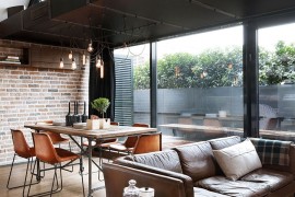 Large glass windows bring in the private balcony indoors