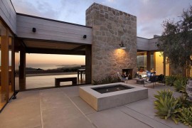 Large stone wall with fireplace shapes a cozy courtyard