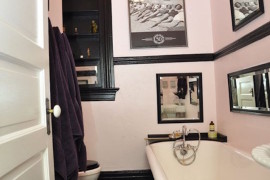 Light pink and black bathrom with retro wall art