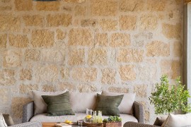 Lovely patio with stone wall and cozy decor